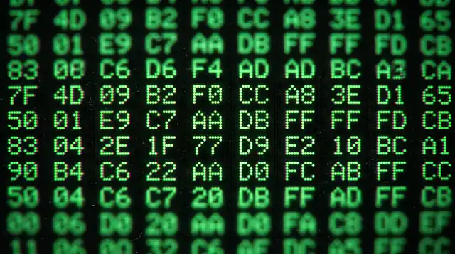 Extreme close-up of a CRT screen showing hexadecimal byte pairs in green phosphor
